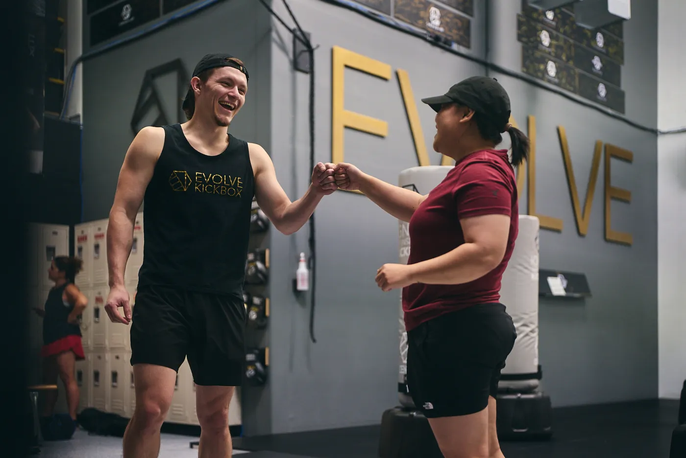 Accountability and community at Evolve Kickbox — members fist-bumping after a workout in Las Vegas