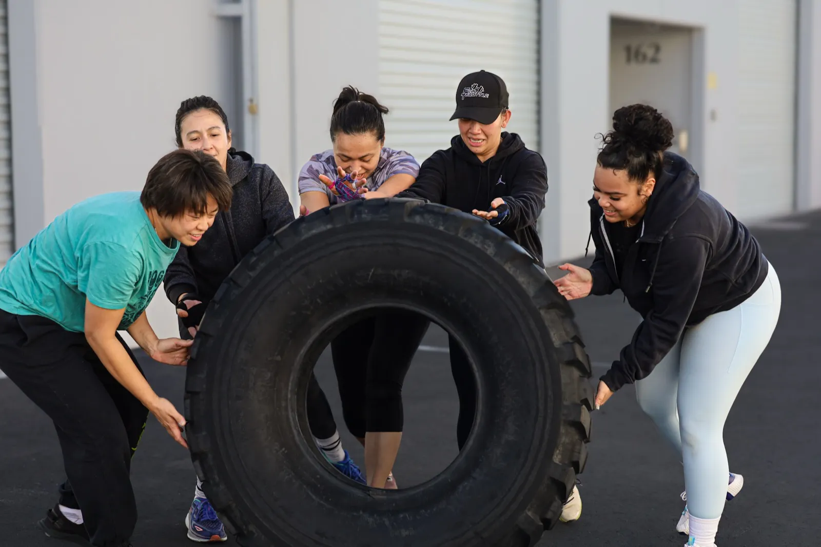 Strength and conditioning at Evolve Kickbox in Las Vegas — a member flipping a training tire